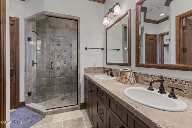 bathroom with an enclosed shower, vanity, and ornamental molding