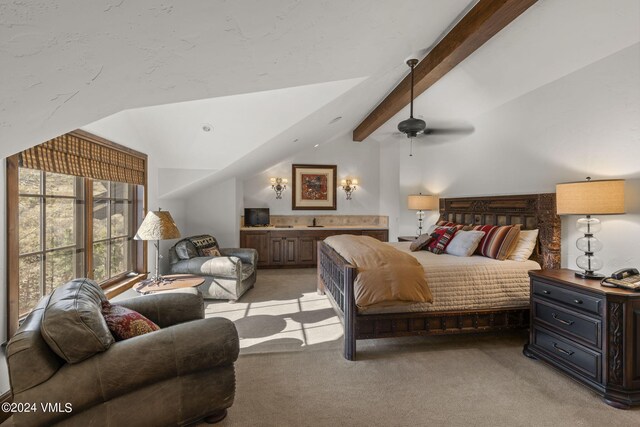 carpeted bedroom with ceiling fan, sink, and vaulted ceiling with beams