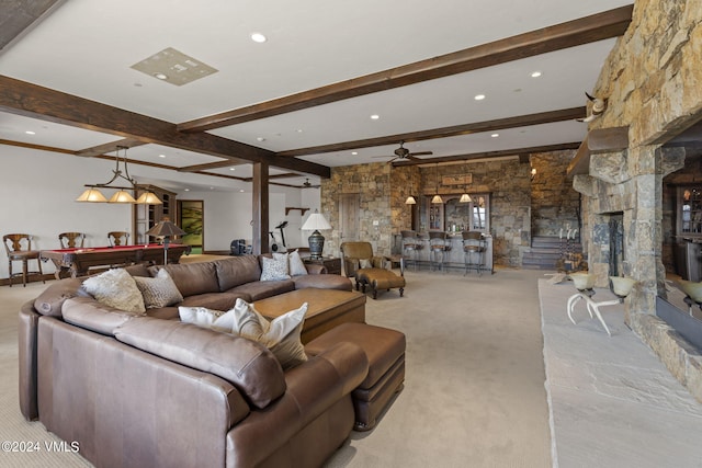 living room with light carpet, a stone fireplace, billiards, and beamed ceiling