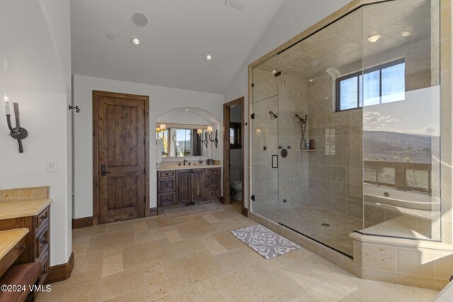 full bathroom featuring vanity, vaulted ceiling, toilet, and plus walk in shower