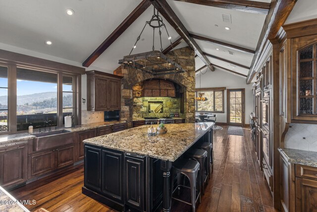 kitchen featuring dark hardwood / wood-style flooring, tasteful backsplash, and a center island