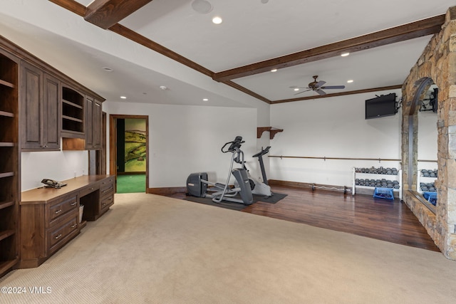 workout area with ornamental molding, built in desk, light colored carpet, and ceiling fan