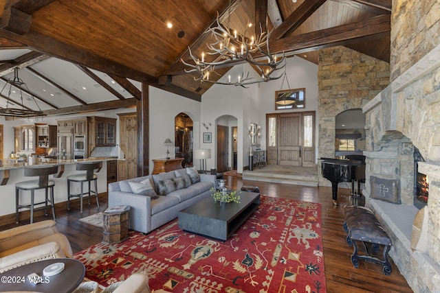 living room featuring wood ceiling, dark wood-type flooring, beam ceiling, high vaulted ceiling, and a chandelier