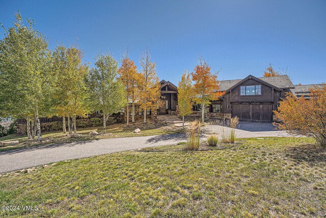 view of front of property with a garage and a front lawn