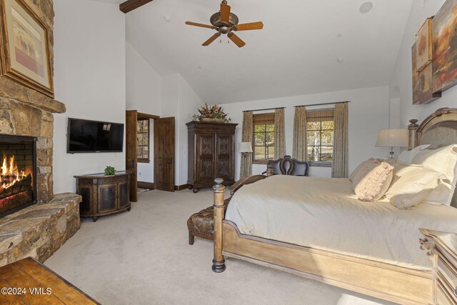 bedroom with ceiling fan, carpet, high vaulted ceiling, and a fireplace