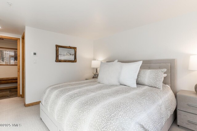 bedroom with light colored carpet