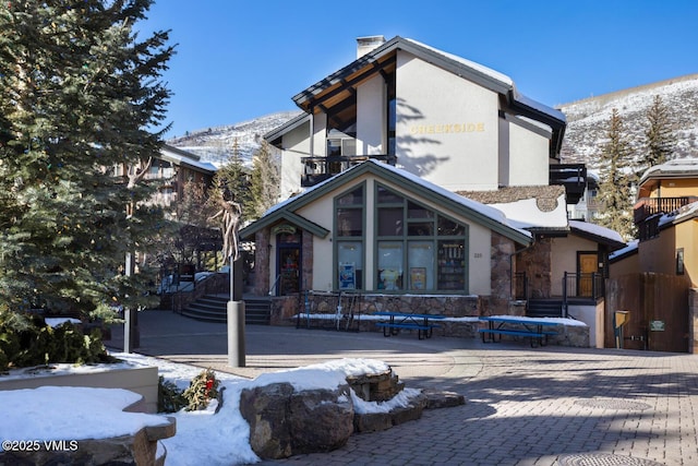 snow covered property with a mountain view