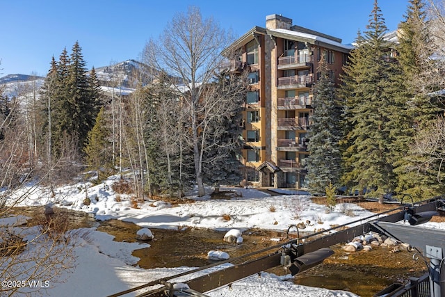 snow covered building with a mountain view