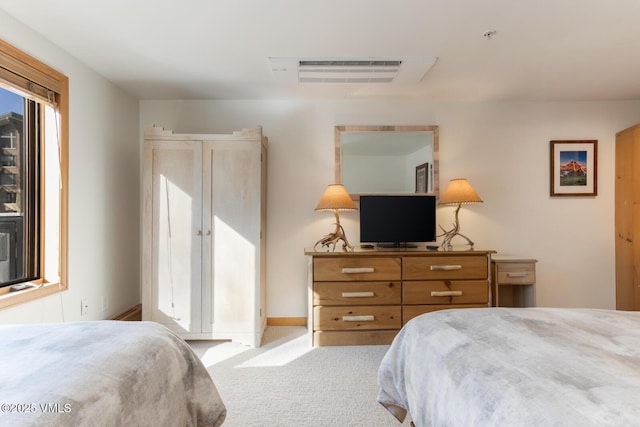 bedroom featuring light carpet