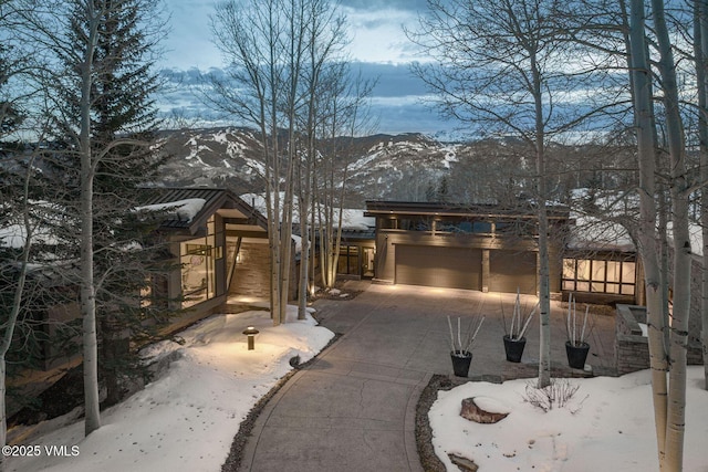 view of front of house with a mountain view and a garage