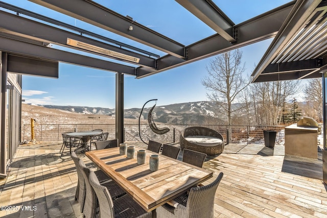 wooden terrace featuring a patio and a mountain view