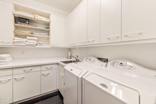 laundry room with washer and dryer, sink, tile patterned flooring, and cabinets