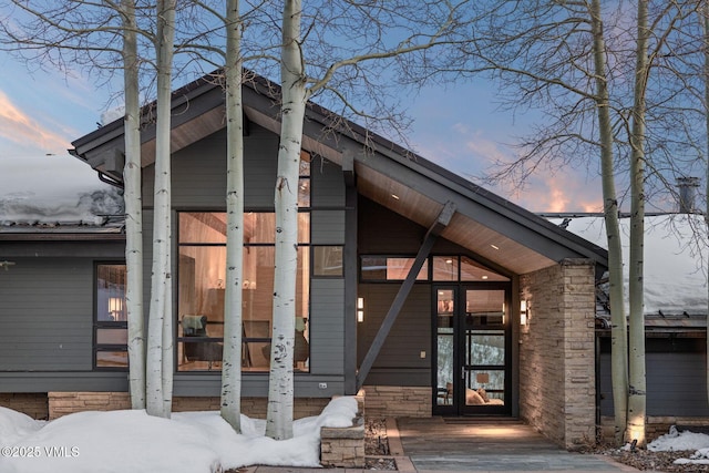 view of snow covered property entrance