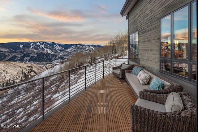 snow covered back of property with a mountain view