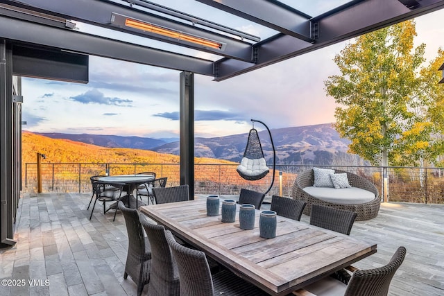 patio terrace at dusk featuring a mountain view