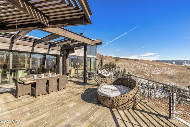 snow covered deck with a pergola and a mountain view