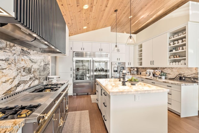 kitchen with a kitchen island with sink, pendant lighting, stainless steel appliances, and white cabinetry