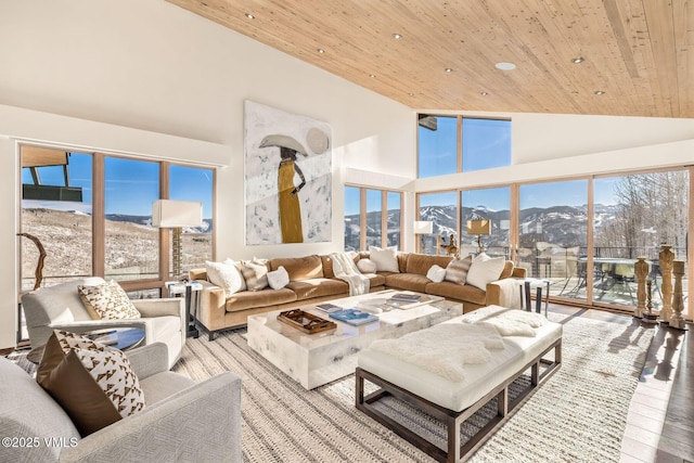 living room with a mountain view, wooden ceiling, high vaulted ceiling, and light wood-type flooring