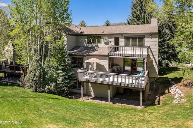 130 Grouse Ct Unit B, Avon, CO 81620 - rear view of house with a deck, a lawn, a shingled roof, a balcony, and a chimney