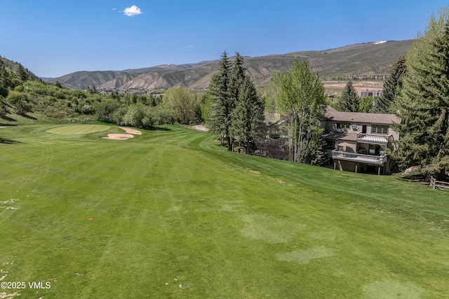 130 Grouse Ct Unit B, Avon, CO 81620 - surrounding community with view of golf course, a mountain view, and a lawn