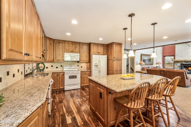 130 Grouse Ct Unit B, Avon, CO 81620 - kitchen with white appliances, a sink, light stone counters, open floor plan, and a center island
