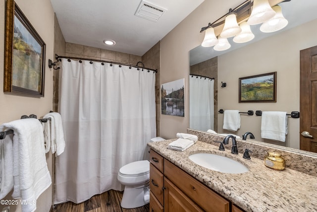 130 Grouse Ct Unit B, Avon, CO 81620 - full bathroom featuring wood finished floors, toilet, vanity, and a shower with shower curtain
