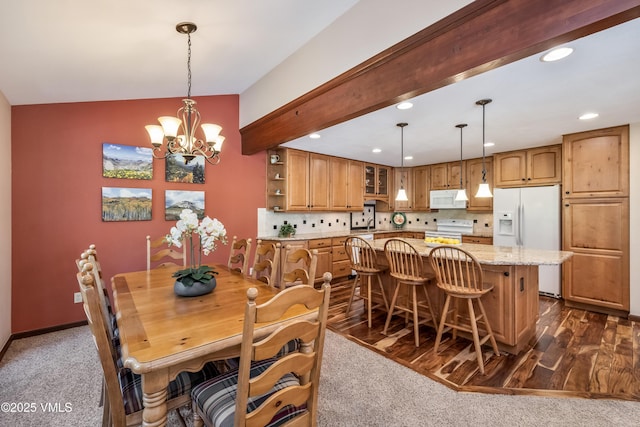 130 Grouse Ct Unit B, Avon, CO 81620 - dining area with recessed lighting, a chandelier, lofted ceiling, dark colored carpet, and dark wood-style flooring