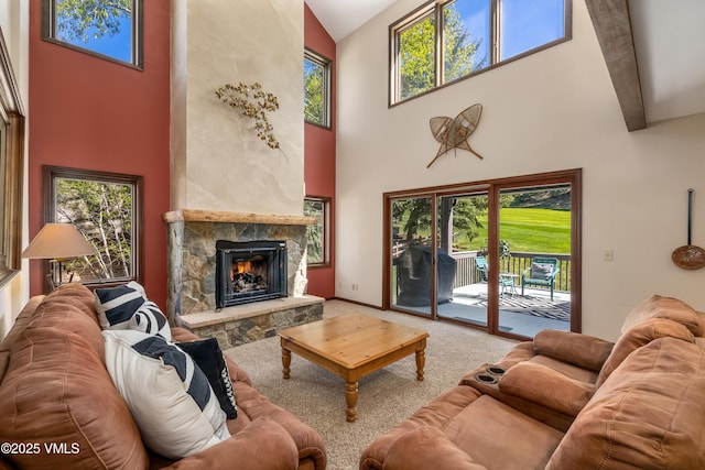 130 Grouse Ct Unit B, Avon, CO 81620 - living room with a high ceiling, a fireplace, healthy amount of natural light, and carpet