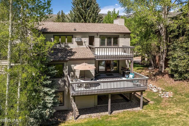 130 Grouse Ct Unit B, Avon, CO 81620 - back of house featuring a shingled roof, a chimney, a deck, a balcony, and a yard
