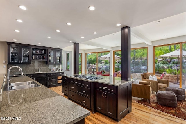 225 Eagle Crest Rd, Edwards, CO 81632 - kitchen featuring ornate columns, stainless steel gas cooktop, open floor plan, light wood-style flooring, and recessed lighting
