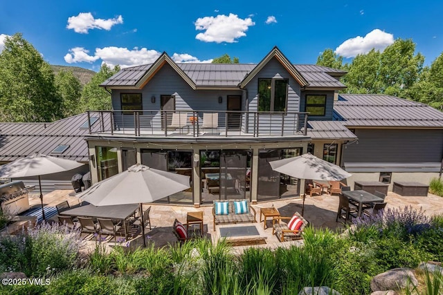 225 Eagle Crest Rd, Edwards, CO 81632 - rear view of property with a balcony, a patio, a standing seam roof, a metal roof, and an outdoor living space