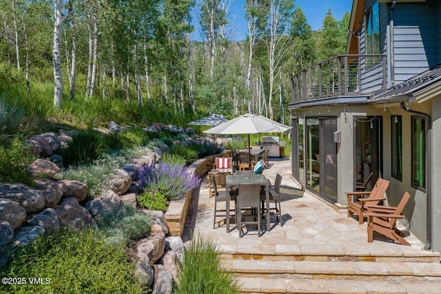 225 Eagle Crest Rd, Edwards, CO 81632 - patio / terrace with a patio area, outdoor dining space, a sunroom, and a view of trees