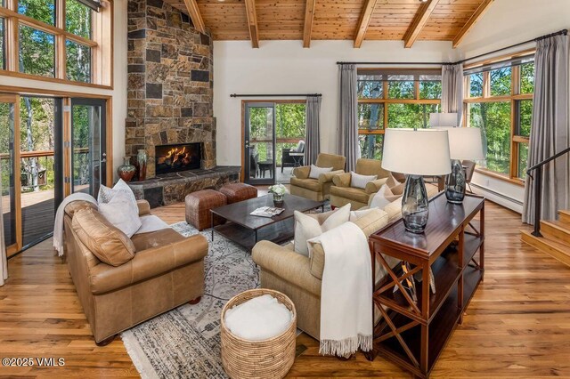 225 Eagle Crest Rd, Edwards, CO 81632 - living room featuring wood ceiling, light wood finished floors, a baseboard heating unit, and a fireplace