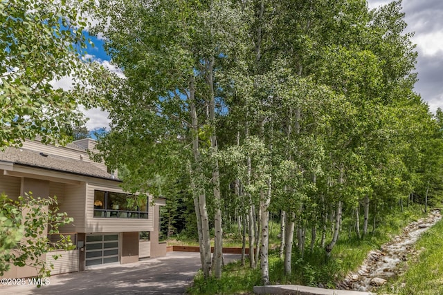 5074 Main Gore Dr S Unit B, Vail, CO 81657 - view of yard featuring asphalt driveway and a garage