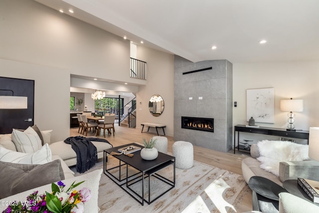 5074 Main Gore Dr S Unit B, Vail, CO 81657 - living room with wood finished floors, recessed lighting, a tiled fireplace, and a chandelier