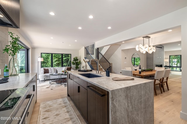 5074 Main Gore Dr S Unit B, Vail, CO 81657 - kitchen with open floor plan, light wood-style floors, dark brown cabinets, light stone countertops, and recessed lighting