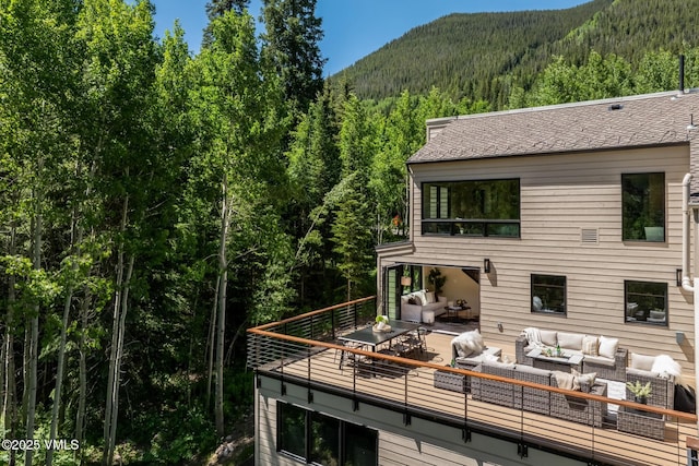 5074 Main Gore Dr S Unit B, Vail, CO 81657 - back of property with outdoor lounge area, a wooded view, and a deck with mountain view