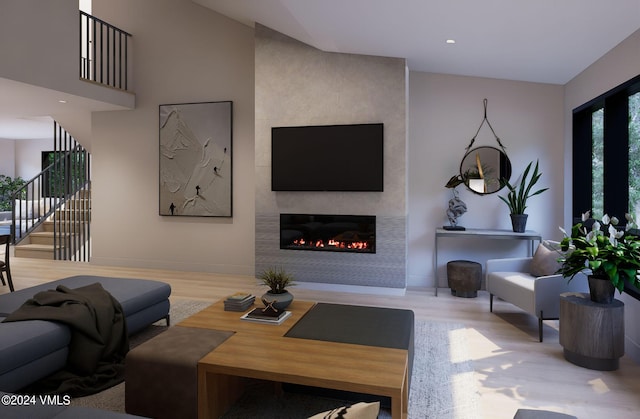 living room featuring wood-type flooring and a fireplace