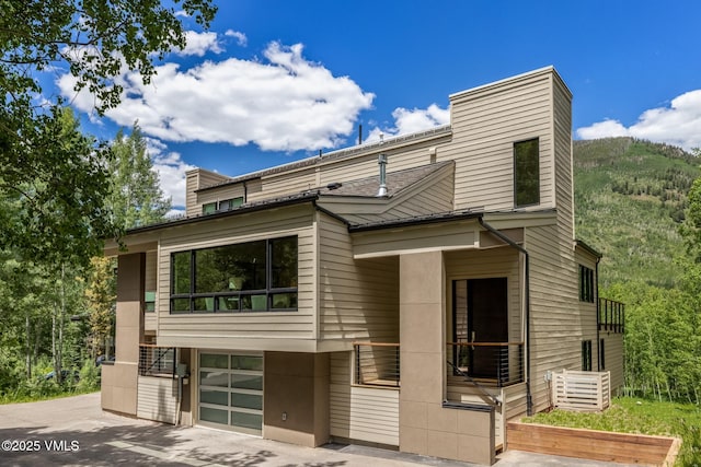 5074 Main Gore Dr S Unit B, Vail, CO 81657 - contemporary home featuring a chimney, an attached garage, and driveway
