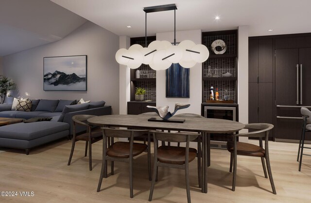 dining area featuring wine cooler and light hardwood / wood-style floors