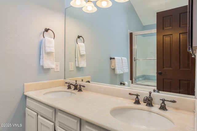 89 Columbine Cir Unit 2, Avon, CO 81620 - full bath featuring double vanity, bath / shower combo with glass door, lofted ceiling, and a chandelier