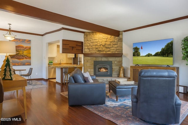 89 Columbine Cir Unit 2, Avon, CO 81620 - living area featuring dark wood finished floors, ornamental molding, and a stone fireplace
