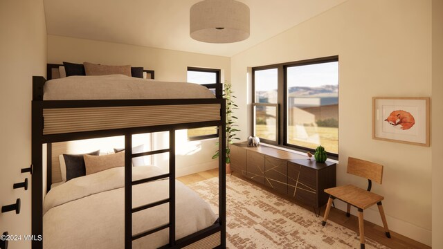 bedroom with hardwood / wood-style flooring and lofted ceiling