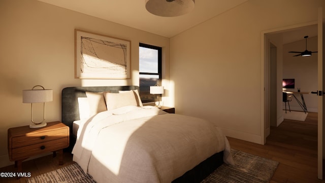 bedroom with hardwood / wood-style flooring and lofted ceiling