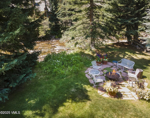4030 Bighorn Rd Lot 1-B, Vail, CO 81657 - view of green lawn featuring an outdoor fire pit