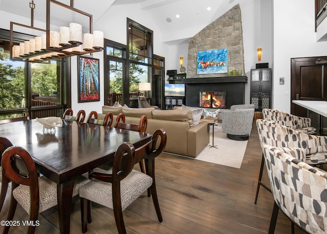 320 Hummingbird Dr Unit A201, Avon, CO 81620 - dining space with high vaulted ceiling, plenty of natural light, dark wood-type flooring, a stone fireplace, and recessed lighting