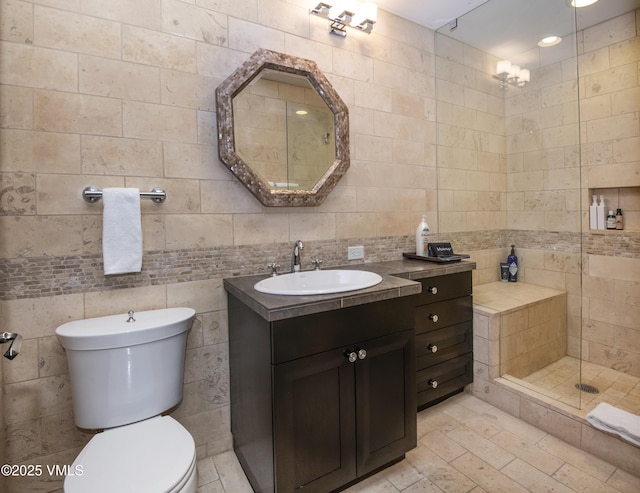 320 Hummingbird Dr Unit A201, Avon, CO 81620 - bathroom featuring tile walls, vanity, a shower stall, and decorative backsplash