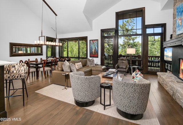 320 Hummingbird Dr Unit A201, Avon, CO 81620 - living area with high vaulted ceiling, a fireplace, hardwood / wood-style flooring, and plenty of natural light