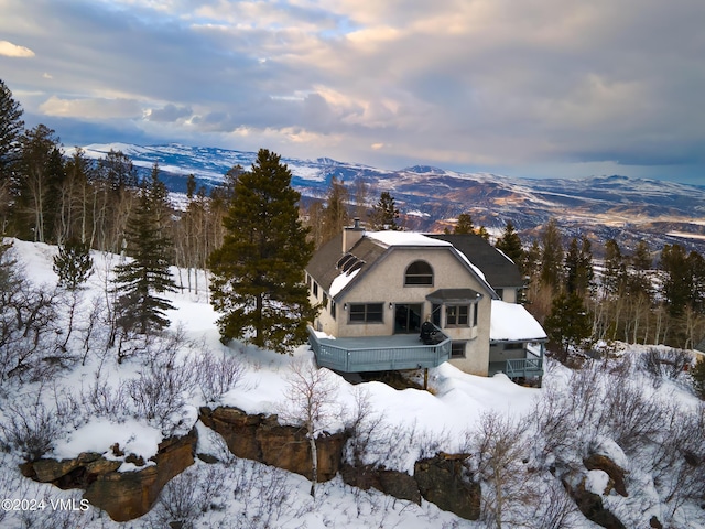 snowy aerial view featuring a mountain view