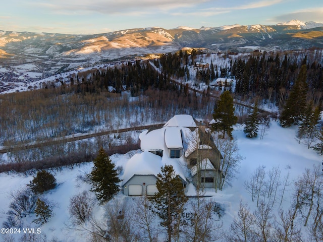 snowy aerial view featuring a mountain view